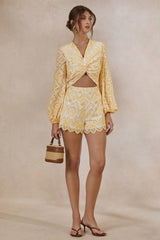 Ksenia | Lemon and White Broderie Plunge-Neck Romper With Twist Detail