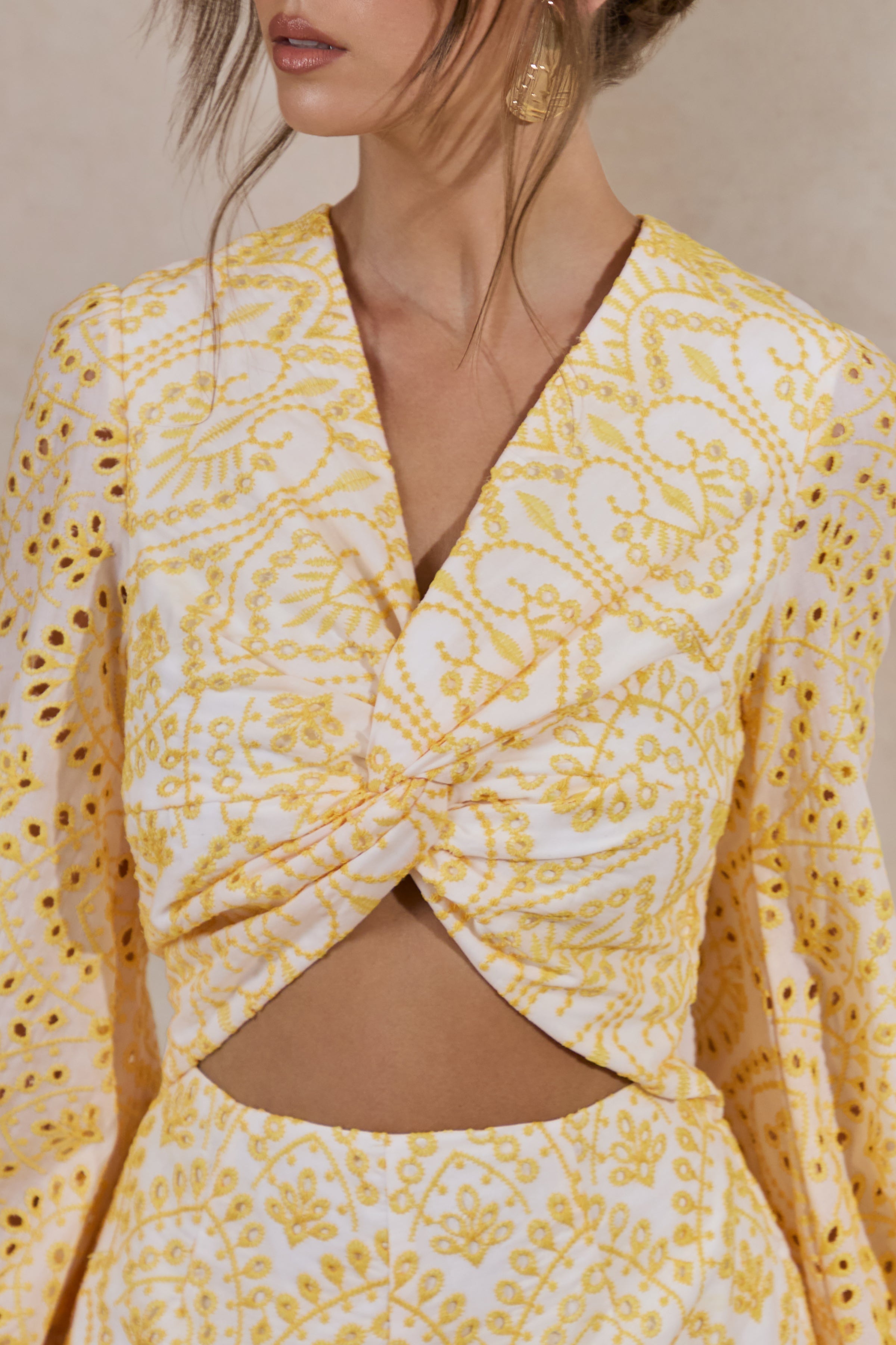 Ksenia | Lemon and White Broderie Plunge-Neck Romper With Twist Detail
